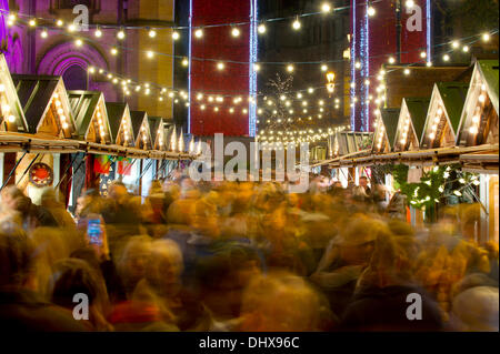 Manchester, UK. 15th November, 2013. Thousands of visitors flock to the 300 Christmas Market stalls spread across various locations in Manchester city centre. This is the 15th year that the Christmas Market has come to town, and is the biggest in Britain. The Markets are located in Corporation Street, King Street and Exchange Square, though the largest is in Albert Square, in front of the town hall. Credit:  Russell Hart/Alamy Live News (Editorial use only). Stock Photo