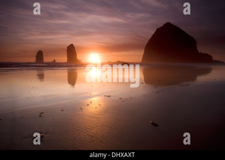 Sunset over Haystack Rock at Canon Beach, Oregon. Stock Photo