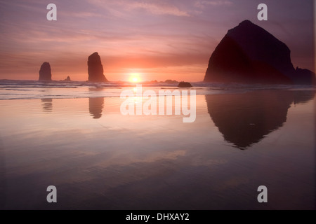 Sunset over Haystack Rock at Canon Beach, Oregon. Stock Photo