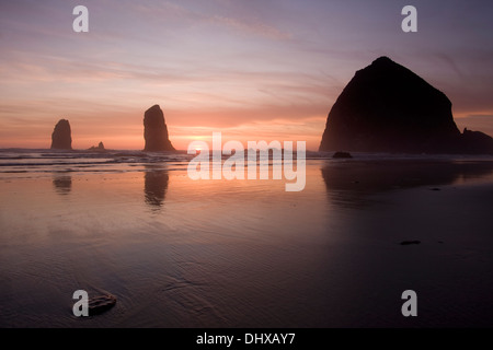 Sunset over Haystack Rock at Cannon Beach, Oregon. Stock Photo