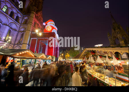 Manchester, UK. 15th November, 2013. Thousands of visitors flock to the 300 Christmas Market stalls spread across various locations in Manchester city centre. This is the 15th year that the Christmas Market has come to town, and is the biggest in Britain. The Markets are located in Corporation Street, King Street and Exchange Square, though the largest is in Albert Square, in front of the town hall. Credit:  Russell Hart/Alamy Live News (Editorial use only). Stock Photo