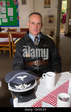A man dressed in German army uniform in a cafe. Haworth 1940s weekend, May 2013. Stock Photo