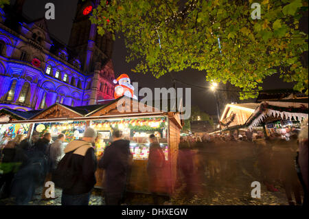 Manchester, UK. 15th November, 2013. Thousands of visitors flock to the 300 Christmas Market stalls spread across various locations in Manchester city centre. This is the 15th year that the Christmas Market has come to town, and is the biggest in Britain. The Markets are located in Corporation Street, King Street and Exchange Square, though the largest is in Albert Square, in front of the town hall. Credit:  Russell Hart/Alamy Live News (Editorial use only). Stock Photo