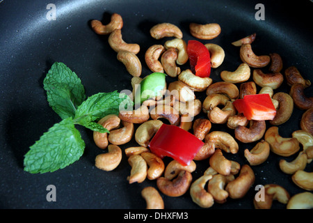 Focus Cashew nuts and bell pepper in pan. Stock Photo