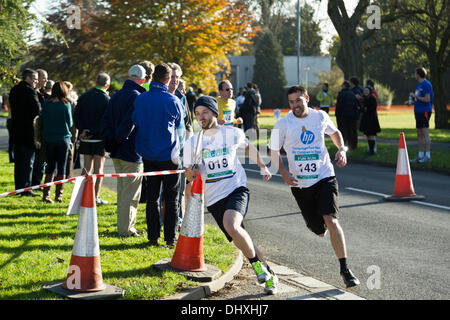 Runners round curve in high school track race Stock Photo - Alamy