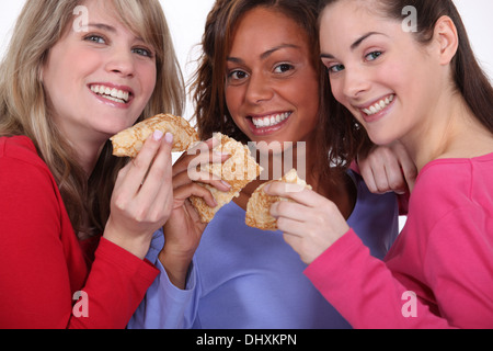three friends eating pancakes Stock Photo
