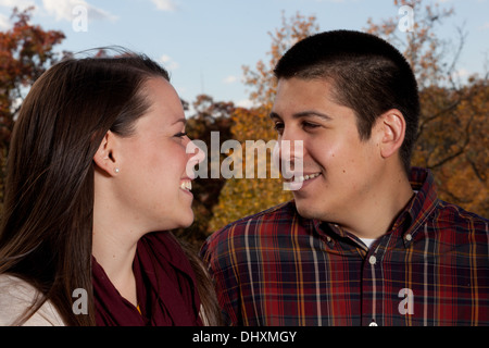 Loving couple looking at each other during the fall / autumn, with natural background Stock Photo