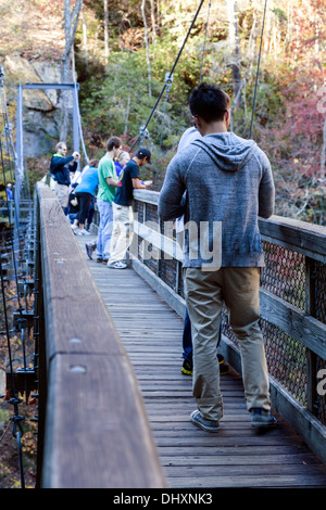 People on a suspension bridge crossing the gorge near the base of Tallulah Falls State Park in Rabun County, Georgia. USA Stock Photo
