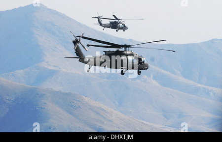 Pair of 10th Combat Aviation Brigade UH-60M Black Hawk helicopters from 1st Battalion (Attack), Task Force Tigershark, is pictured out the crew chief's window during a personnel movement mission Nov. 11, over Logar province, Afghanistan. Stock Photo