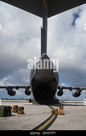 A C-17 Globemaster III is parked Nov. 15, 2013, on the Andersen Air Force Base, Guam, flightline, before departing to transport Stock Photo