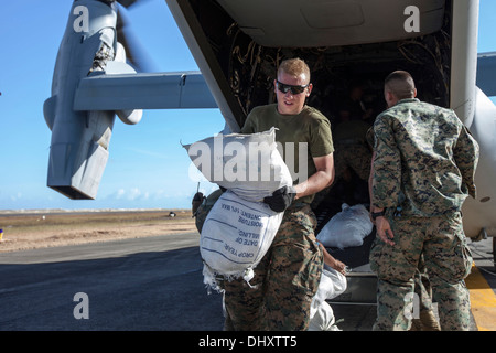 Marines with Marine Medium Tiltrotor Squadron 262, 1st Marine Air Wing, offload relief supplies at Tacloban Air Field here, Nov.
