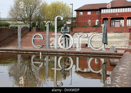 A statue of the great engineer Thomas Telford leaning on the letters of the town in Shropshire named after him Stock Photo