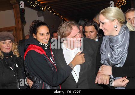 Roxanna (21), daughter of Gerard Depardieu, Gerard Depardieu and Kathrin Glock (left to right), wife of manufacturer Gaston Glock 'Glock' pistols pose at the opening of the traditional Christmas market on Aiderbichl, the animal paradise for homeless animals on 14 November 2013 in the village Henndorf near Salzburg in Austria. Stock Photo