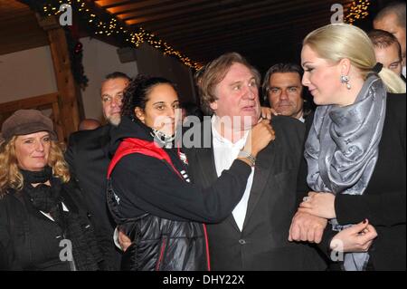 Roxanna (21), daughter of Gerard Depardieu, Gerard Depardieu and Kathrin Glock (left to right), wife of manufacturer Gaston Glock 'Glock' pistols pose at the opening of the traditional Christmas market on Aiderbichl, the animal paradise for homeless animals on 14 November 2013 in the village Henndorf near Salzburg in Austria. Stock Photo