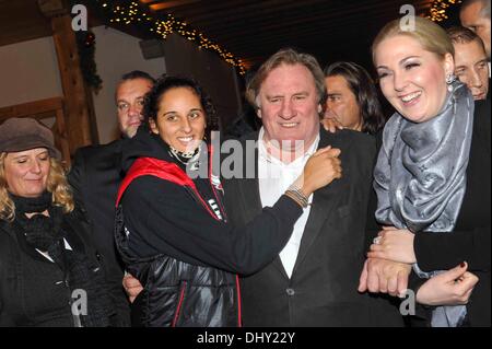 Roxanna (21), daughter of Gerard Depardieu, Gerard Depardieu and Kathrin Glock (left to right), wife of manufacturer Gaston Glock 'Glock' pistols pose at the opening of the traditional Christmas market on Aiderbichl, the animal paradise for homeless animals on 14 November 2013 in the village Henndorf near Salzburg in Austria. Stock Photo