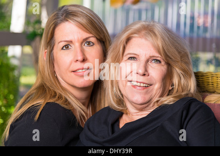 Portrait of two women, mother and daughter, 61 and 44 years old. Caucasian ethnicity. Stock Photo