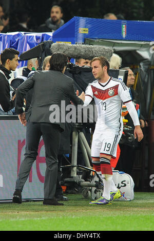 Milan, Italy. 15th Nov, 2013. Germany's national soccer coach Joachim Loew (L) and Germany's Mario Goetze shake hands during the friendly soccer match between Italy and Germany at Giuseppe Meazza Stadium (San Siro) in Milan, Italy, 15 November 2013. Photo: Revierfoto/dpa - NO WIRE SERVICE -/dpa/Alamy Live News Stock Photo