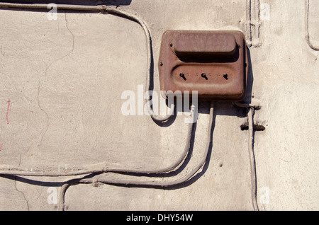 Old  electric rusted circuit breaker on a grunge house wall Stock Photo
