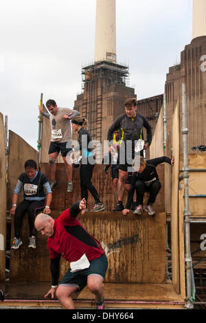 Battersea, London, UK. 16th November 2013. Competitors negotiate another obstacle on the course at the Men's Health Survival of the Fittest 2013 event at Battersea Power Station. Credit:  Paul Davey/Alamy Live News Stock Photo