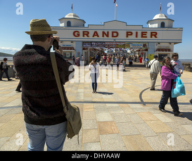 Man taking photo in front of Grand Pier entrance Weston-Super-Mare Stock Photo