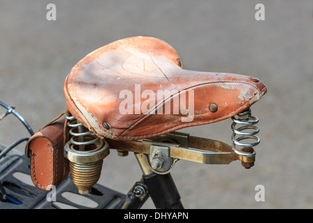 Details of vintage leather bike saddle with metal springs Stock Photo