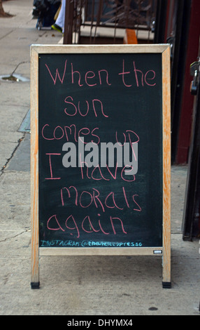 Sign outside Elsewhere Espresso on East 6th Street in the East Village NYC saying "When The Sun Comes Up I have morals again." Stock Photo