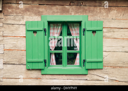 Wooden window with hearts on traditional log cabin Stock Photo