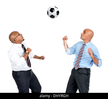 Businessmen playing soccer ball isolated in white Stock Photo