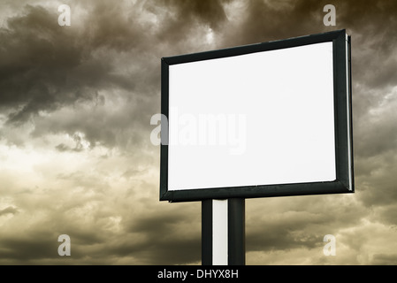 Blank Billboard with empty screen over dark stormy clouds Stock Photo