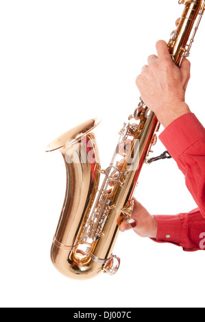 Male entertainer playing a brass tenor saxophone with silver valves and pearl buttons in close up Stock Photo