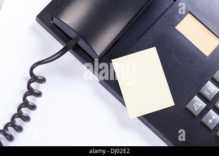 memo post it message on telefone in office reminder object business Stock Photo