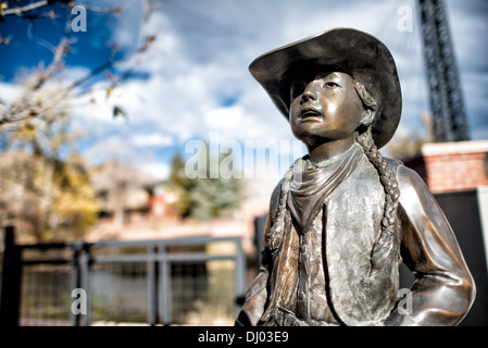 Girl In Western Dress Statue Golden Colorado // A statue of a girl in western dress in Golden, Colorado, just outside Denver at the eastern edge of the Rocky Mountains Stock Photo - Girl In Western Dress Statue Golden Colorado // A statue of a girl in western dress in Golden, Colorado, just outside Denver at the eastern edge of the Rocky Mountains Stock Photo -