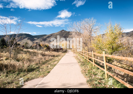 GOLDEN, Colorado - A path runs along Clear Creek in Golden, Colorado, just outside Denver at the eastern edge of the Rocky Mountains. Founded during the Pike's Peak Gold Rush, Golden today is known for its rich heritage, outdoor activities, and being the birthplace of Coors Brewery, embodying a unique blend of history, culture, and natural beauty. Stock Photo