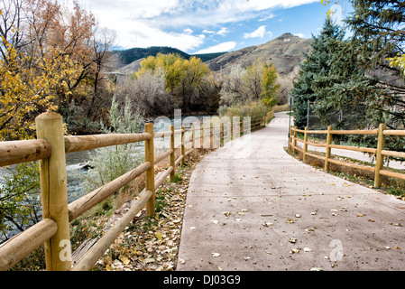 GOLDEN, Colorado - A walking path runs along the edge of Clear Creek in Golden, Colorado, just outside Denver at the eastern edge of the Rocky Mountains. Founded during the Pike's Peak Gold Rush, Golden today is known for its rich heritage, outdoor activities, and being the birthplace of Coors Brewery, embodying a unique blend of history, culture, and natural beauty. Stock Photo