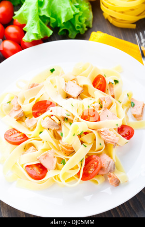 Delicious fettuccini with salmon and tomatoes Stock Photo