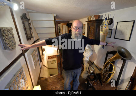 Eisenach, Germany. 07th Nov, 2013. Klaus Trippstein, resident and owner of the 'Narrow House', poses in his house in Eisenach, Germany, 07 November 2013. With a width of 2.05 meters, it is probably the smallest inhabited half-timbered house in Germany. Klaus Trippstein's research has shown that the house is over 250 years old. Klaus Trippstein had bought the house in the mid-seventies and restored it piece by piece. The house hosts a small exhibition of paintings, sculptures and historic furnishings. Photo: Marc Tirl/dpa/Alamy Live News Stock Photo
