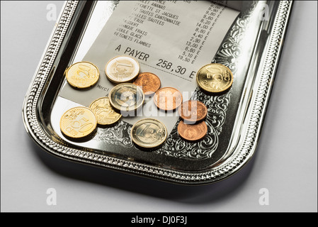 Restaurant till receipt with Euro coins on cash tray Stock Photo