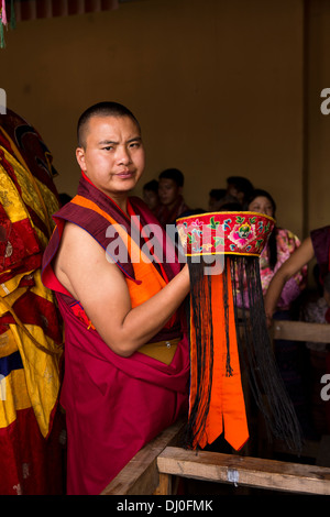 Bhutan, Thimpu Dzong, annual Tsechu, senior monk holding embroidered ceremonial hat Stock Photo