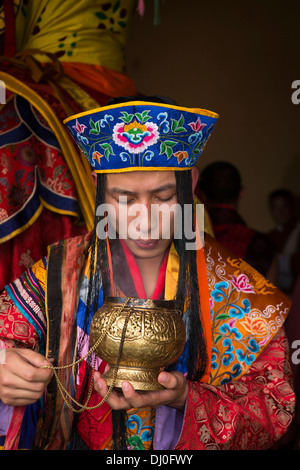 Bhutan, Thimpu Dzong, annual Tsechu, monk in embroidered costume lighting incense Stock Photo