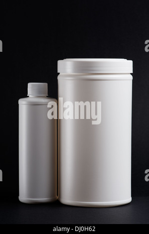 White medicine bottles on black background Stock Photo
