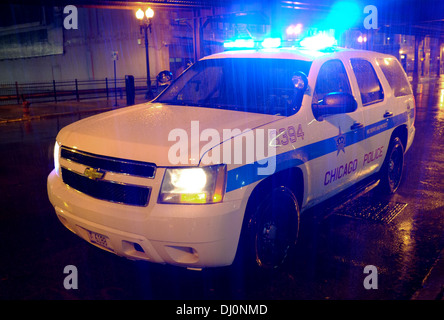 Chicago Police Chevrolet Chevy Tahoe (2006 - 2014) full size SUV 4x4 car with blue lights flashing in heavy early morning rain Stock Photo