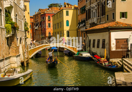 Gondolier taking passengers for an informative gondola ride in Venice, Italy. Stock Photo