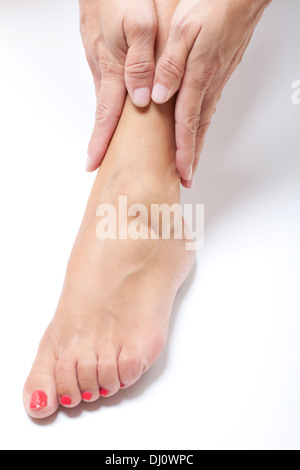 woman massaging ankles Stock Photo