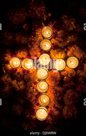 A cross made of candles decorate a tomb during the Day of the Dead in the cemetery of Santa Cruz Xoxocotlan, Oaxaca, Mexico Stock Photo