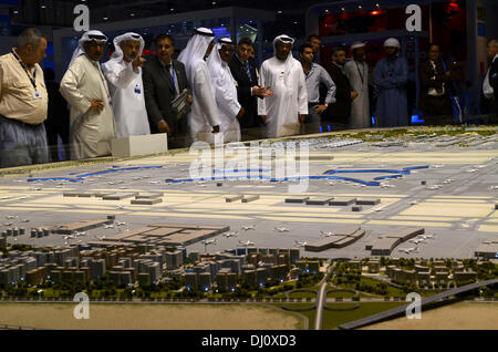 Dubai. 18th November 2013: Springing out of the desert - visitors to the 2013 Dubai Air Show take a look at a scale model of the new Al Maktoum International Airport, which will be better known as Dubai World Central (DWC).  When the development is complete it will cover 140 square kilometres and include the airport, an exhibition centre, golf district, flight academy and city complete with private and commercial premises.  Situated almost mid-way between Abu Dhabi and Dubai, it will eventually handle 12 million tons of cargo and 160 million passengers a year. Stock Photo