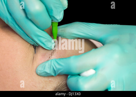 Applying Permanent Makeup on Eyebrow Stock Photo