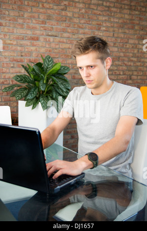 Young man working on laptop Stock Photo