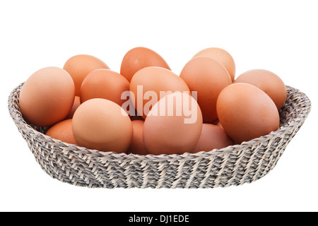 twenty fresh chicken eggs in wicker basket isolated on white background Stock Photo