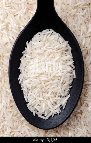 Top view of black spoon full of basmati rice Stock Photo