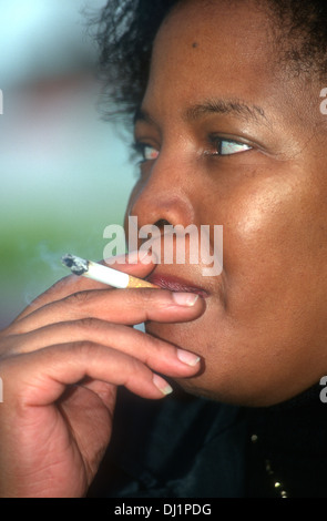black smoking cigarette woman smoking, London, UK Stock Photo Angela Davis smokes a cigarette